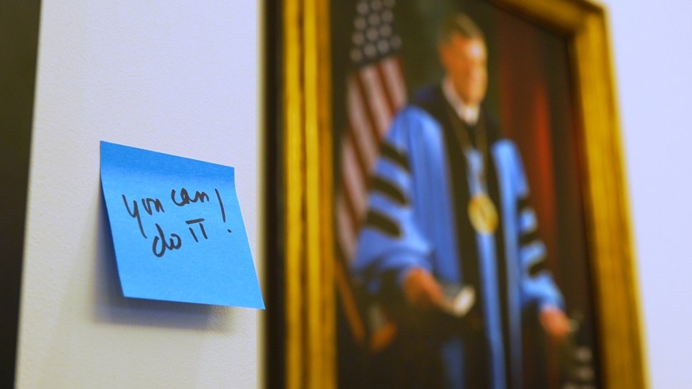 Sticky note reading "You can do it!" next to a portrait of T. Haas